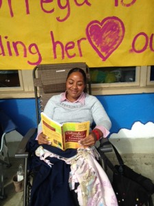 Principal La Ronda Ortega reading in a lawn chair outside of the school library.