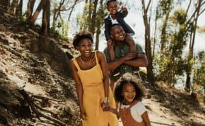 A family enjoys nature with a hike. Try some fun nature activities.