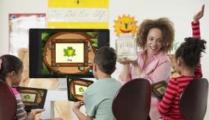 Students using digital tablets in class with Waterford