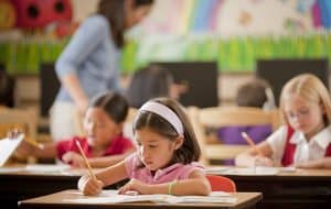 students work on workbooks in classroom