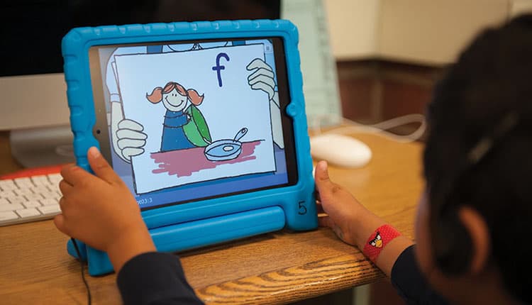 young boy uses Waterford on ipad
