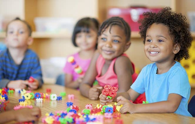 kindergarten children playing with toys