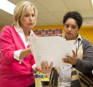 Waterford professional development team member helps teacher look at reports.
