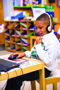 boy using Waterford on desktop computer