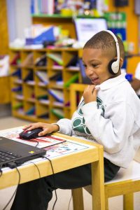 boy using Waterford on desktop computer