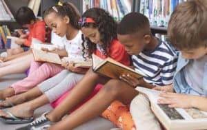 Children reading books in a school library.