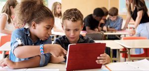 School kids in class using a digital tablet