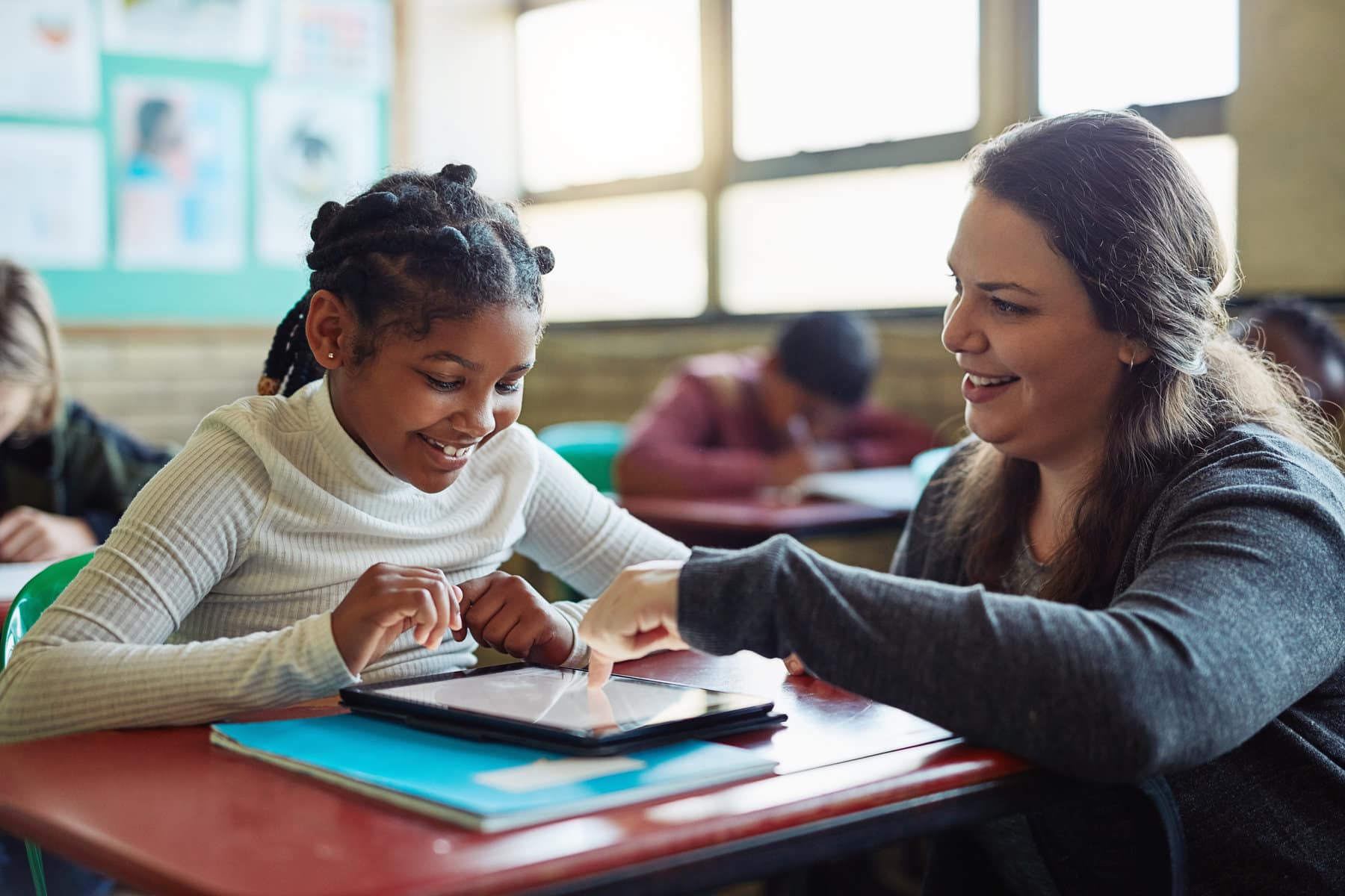 teacher and student working on an assignment in the classroom