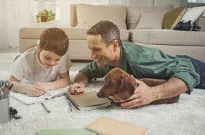 father teaching son how to write