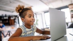 girl watching back to school night on laptop