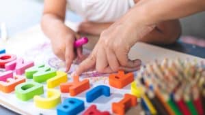 Child and parent learning the alphabet together with plastic letters