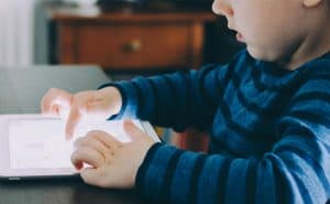 Young student on a device at home