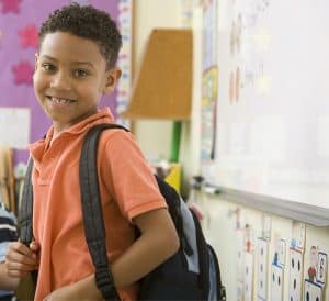 A young, confident student in the safety of a classroom
