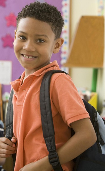 A young, confident student in the safety of a classroom