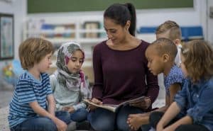 Students hearing a story as part of written communication skill building