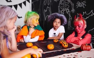 Young children, some in homemade recycled costumes, at a party