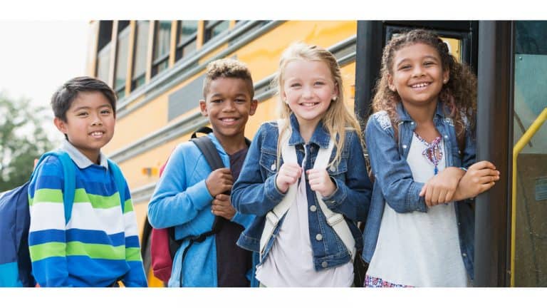 Different students getting on a school bus