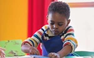 Boy doing winter crafts. Find holiday crafts for children