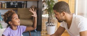 A father quizzing his daughter at the kitchen table