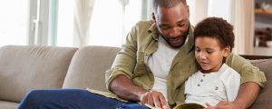 Father and son reading together. Spending quality time together is a good way to help your child cope with stress