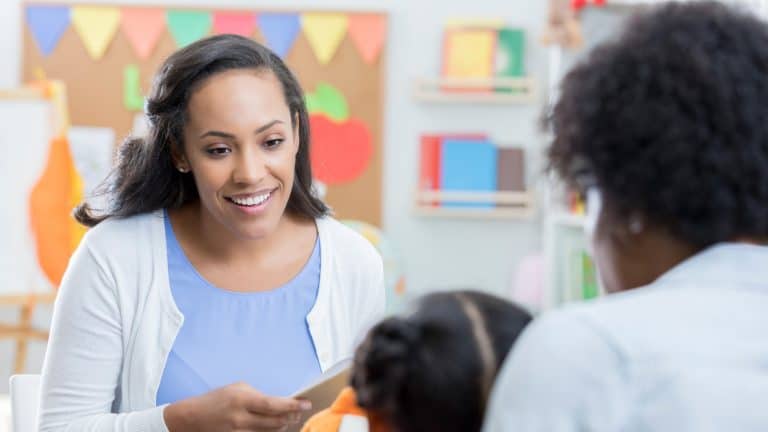 A speech therapist meeting with a teacher and child