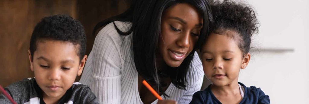 A mom does crafts with her children.