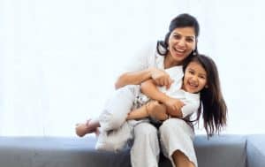 a mother and a child smiling