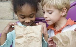 Children share a lunch. Find help getting nutrition for your family