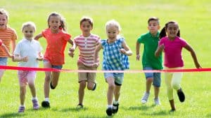 Children having a race outside. Find some exciting boredom-busting activities here.