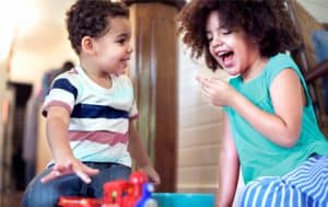 Two children play with toys together.