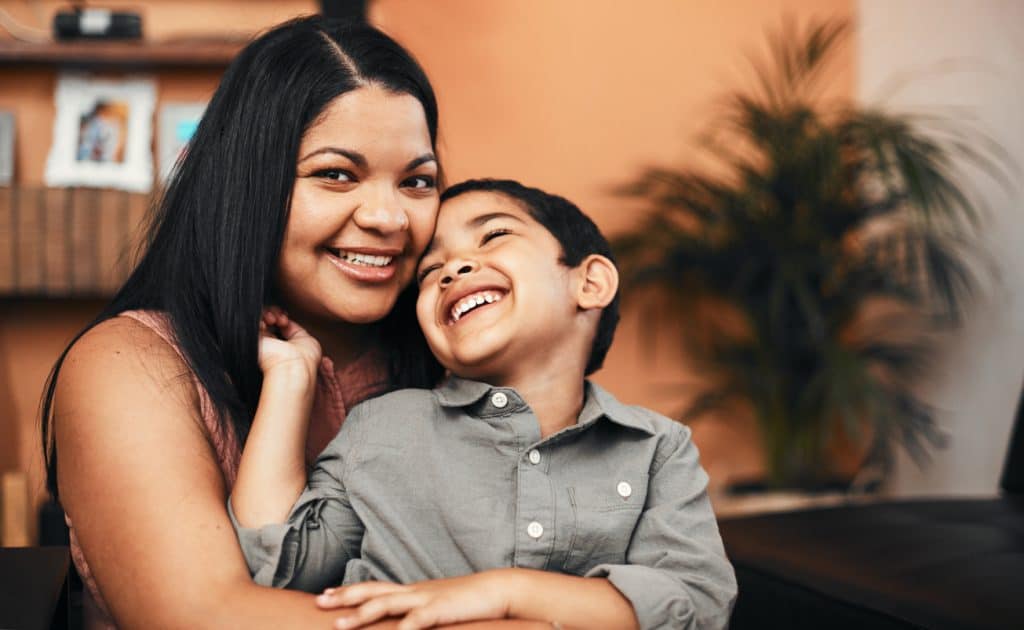 Portrait of a mother bonding with her little son at home