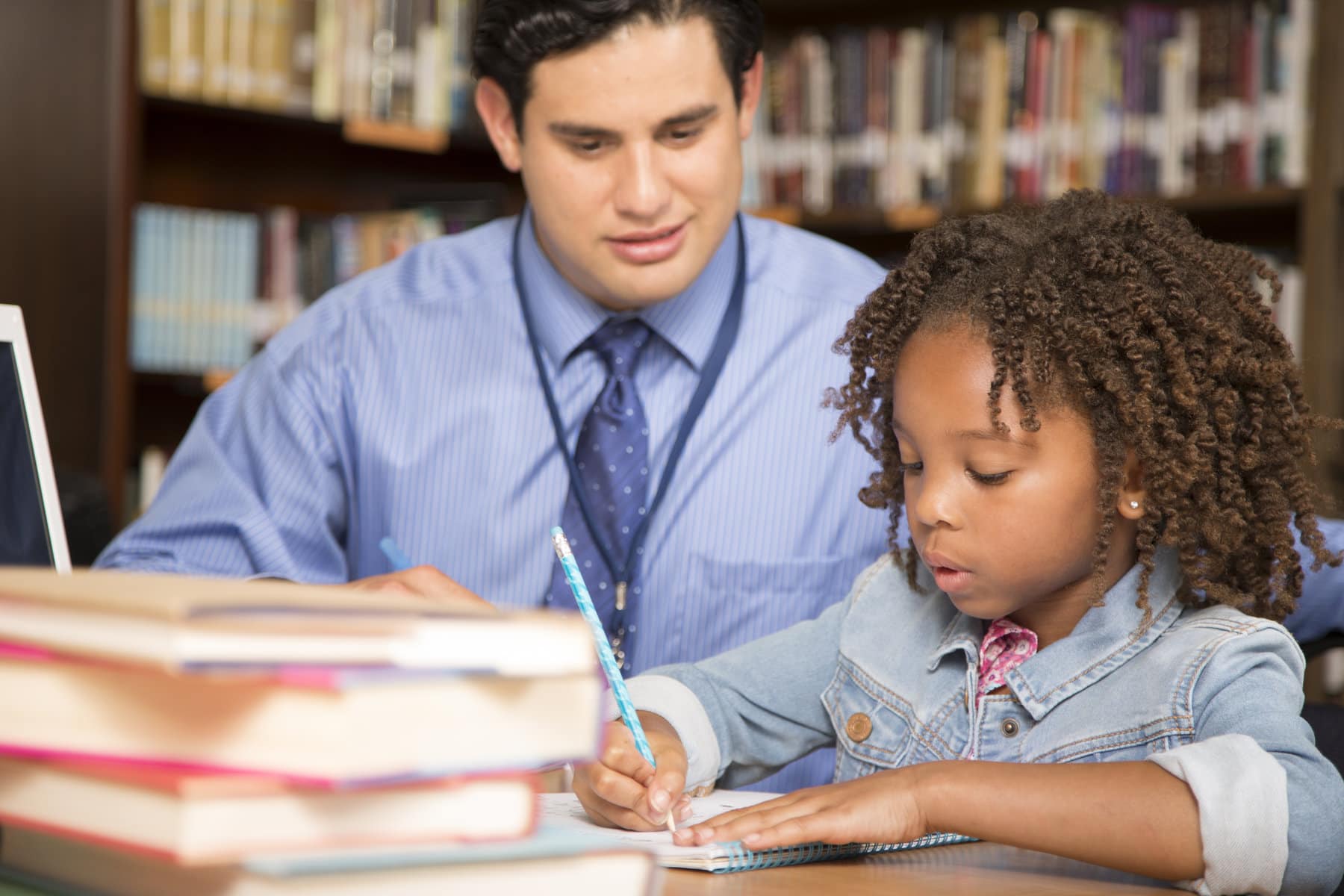 an educator teaching a student reading skills