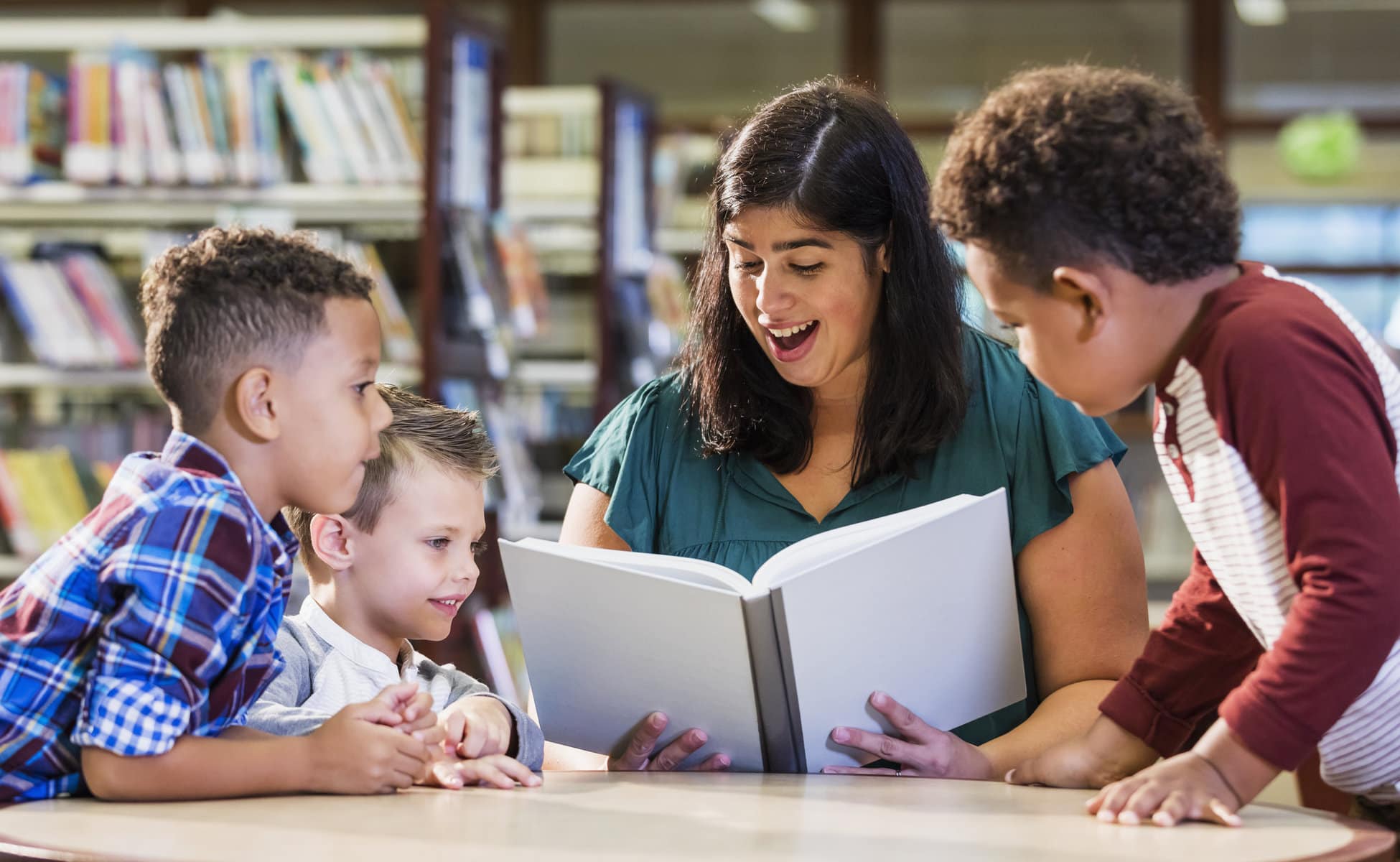 a teacher reading a book to her students