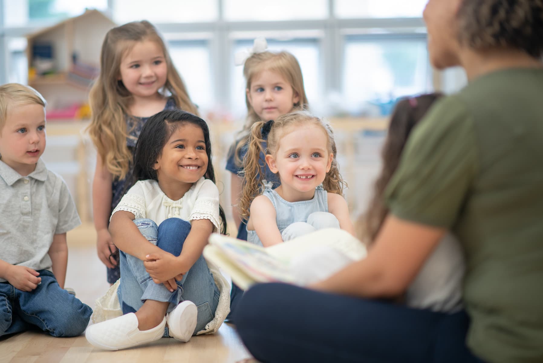 students listening to teacher reading a book