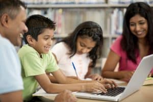 family using a computer at the library