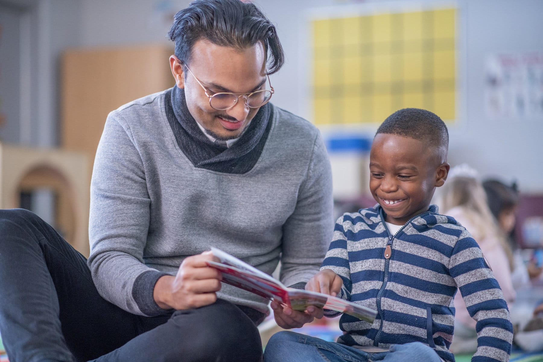 teacher and student reading a book