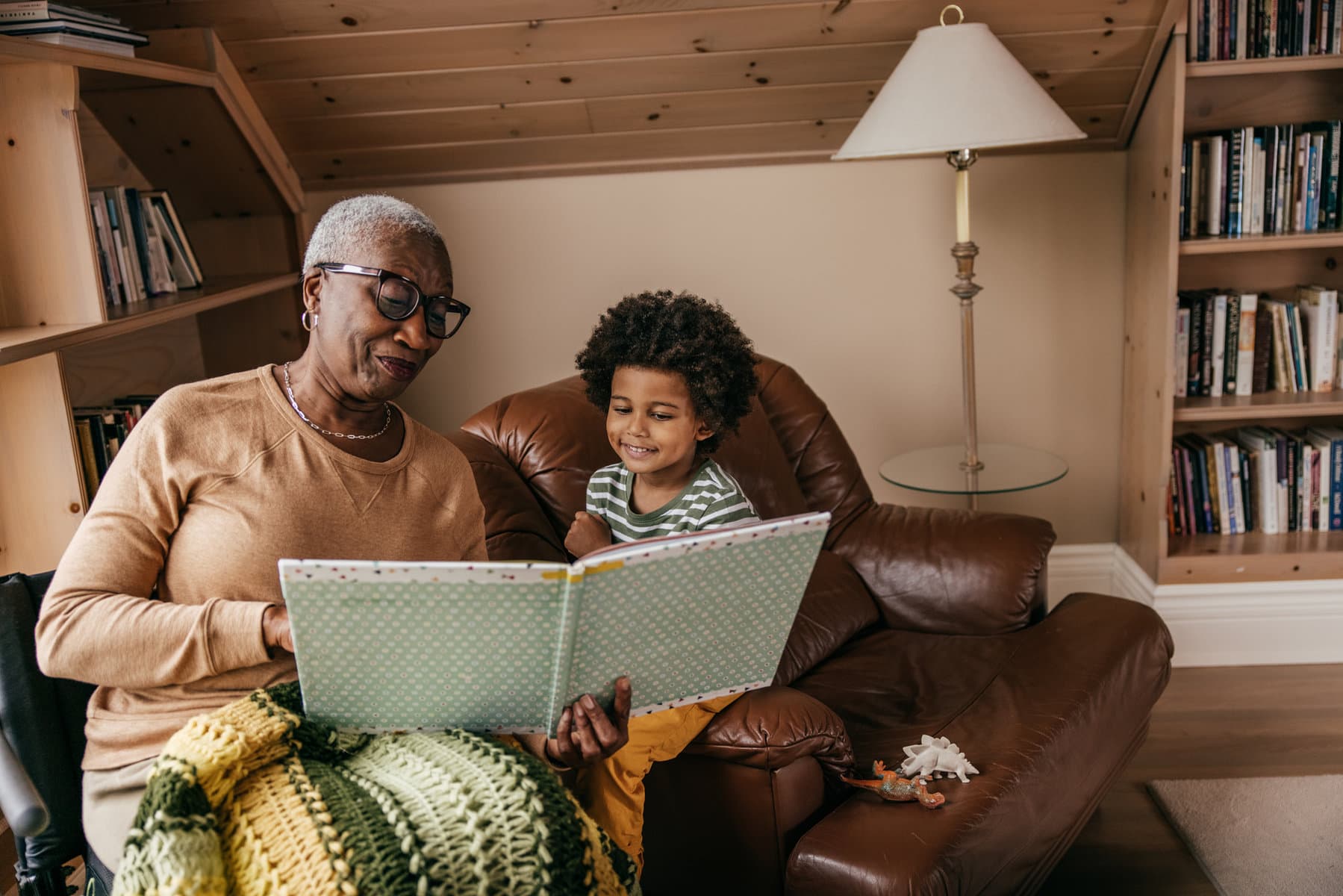 older caregiver and child reading a book
