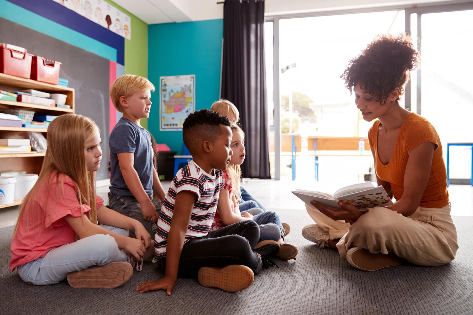 teacher reading a book for classroom story time