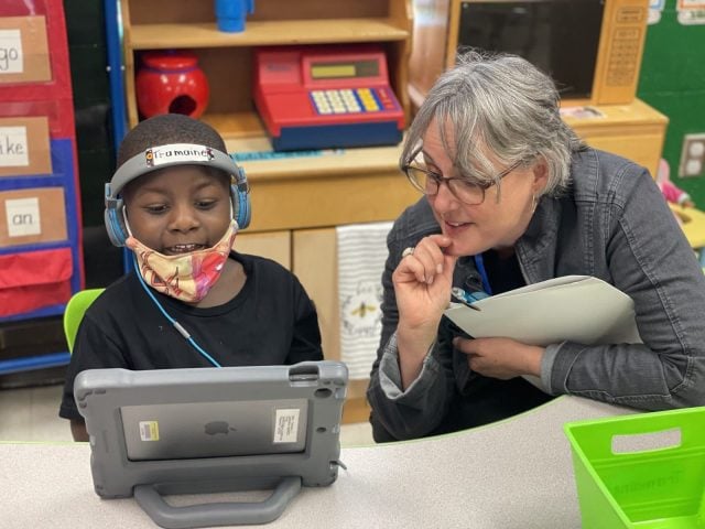 Teacher working with child